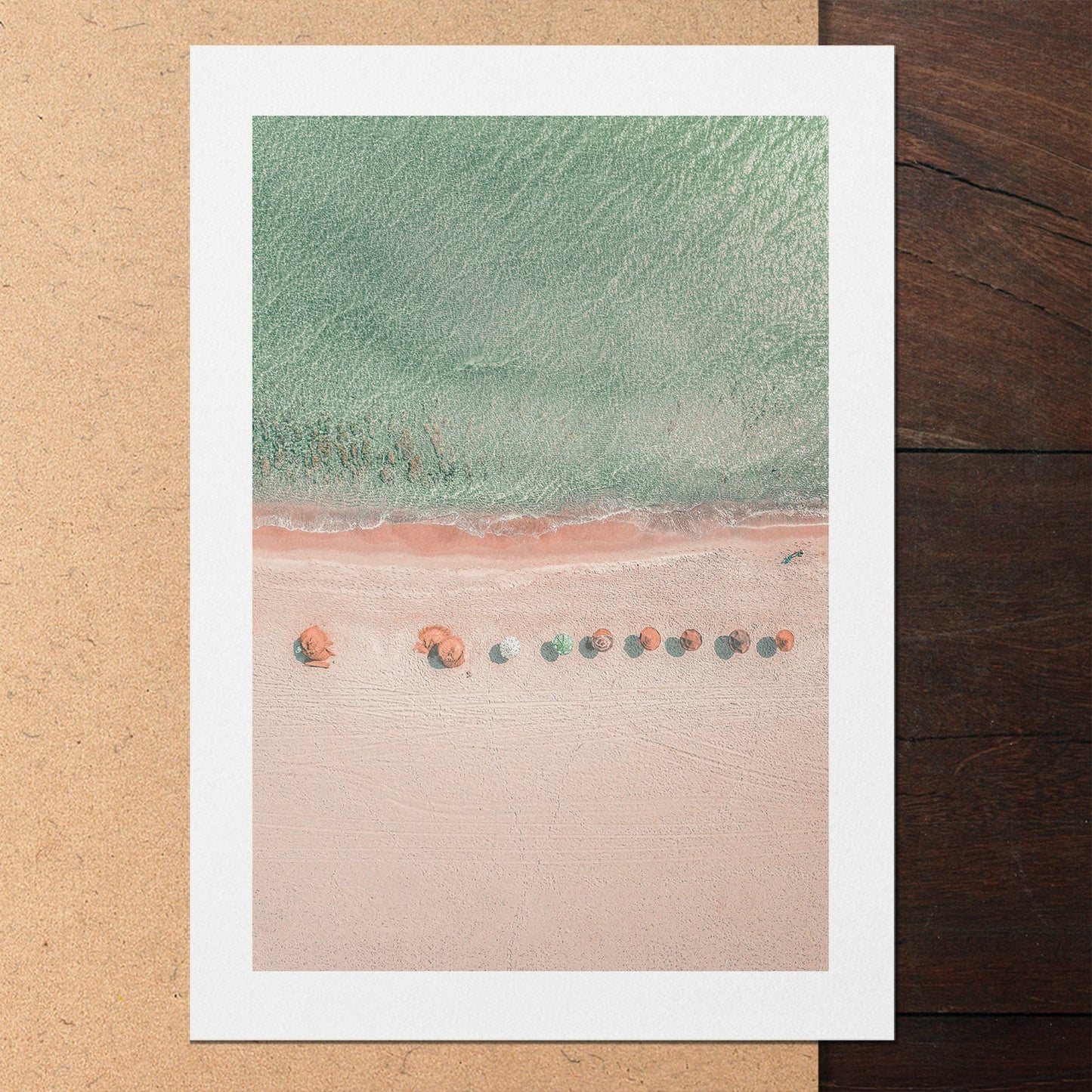 An unframed poster print of a beach in pastel tones