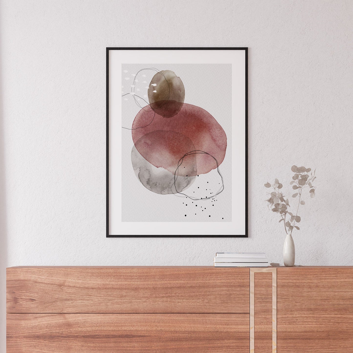 Interior sideboard decor with a framed abstract print in red and brown