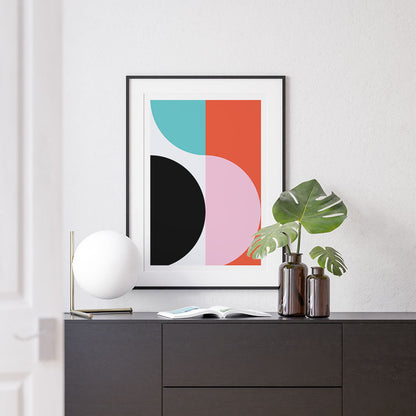 A framed art print featuring geometric circles in bright colors