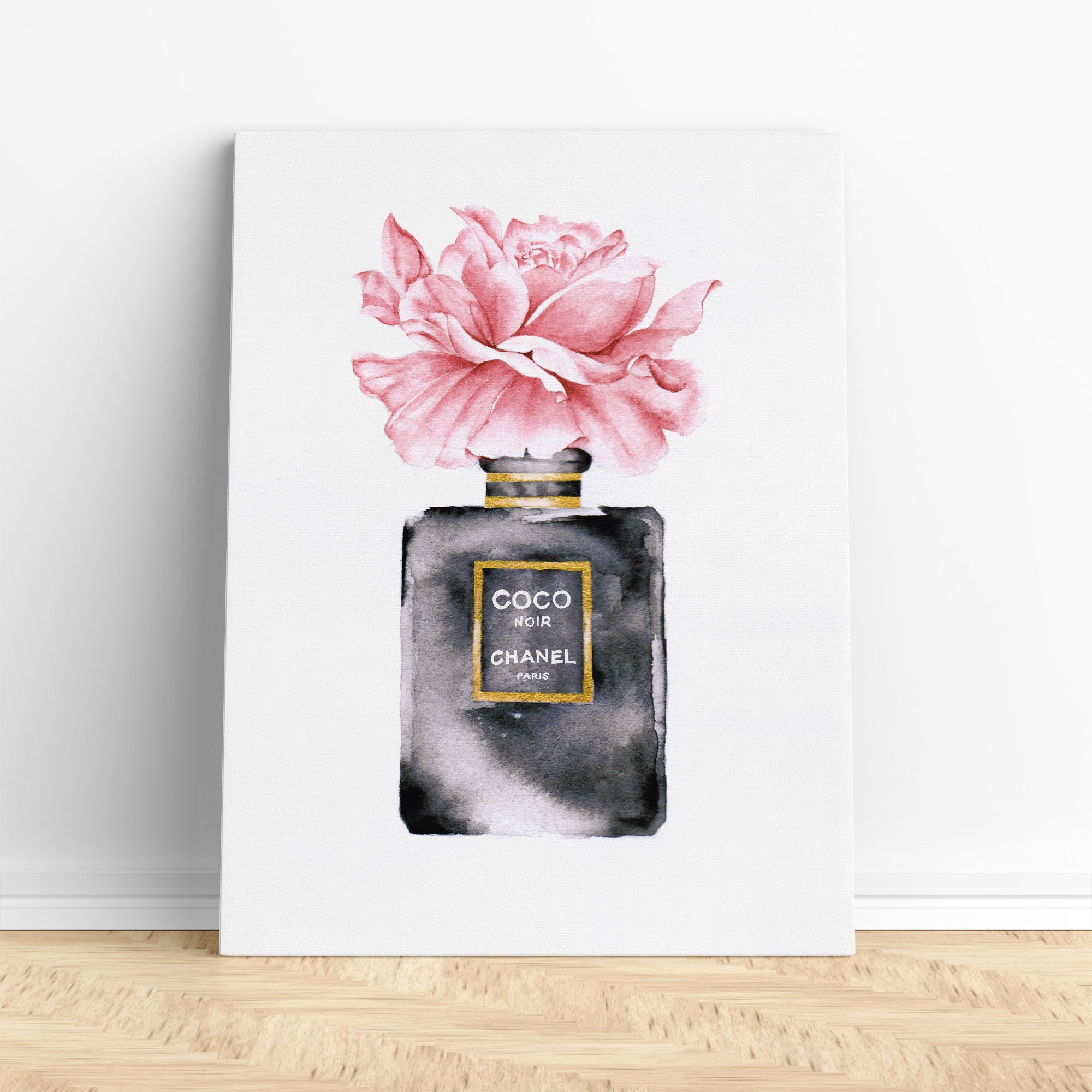 A bottle of chanel perfume next to a hat and flowers photo – Free