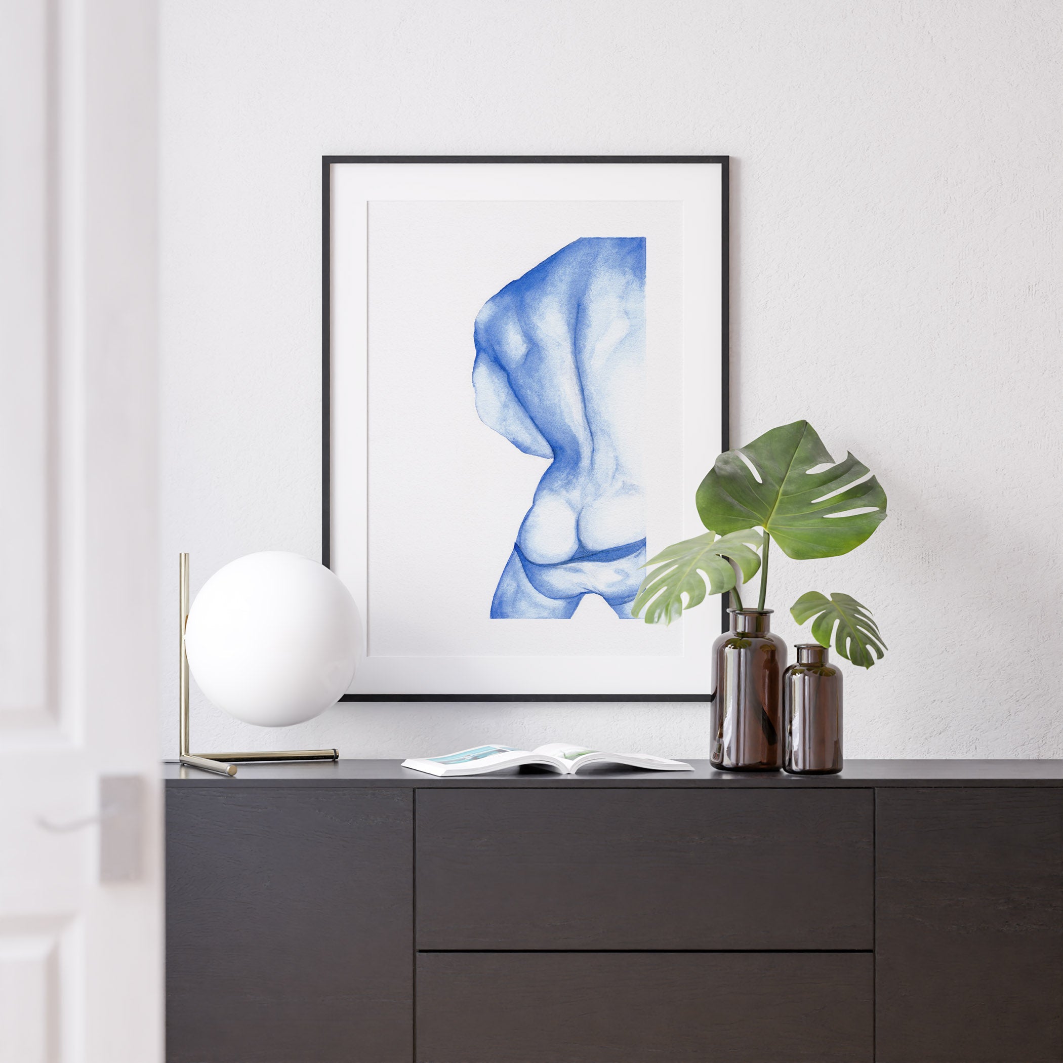 A watercolor print of a nude male body from behind