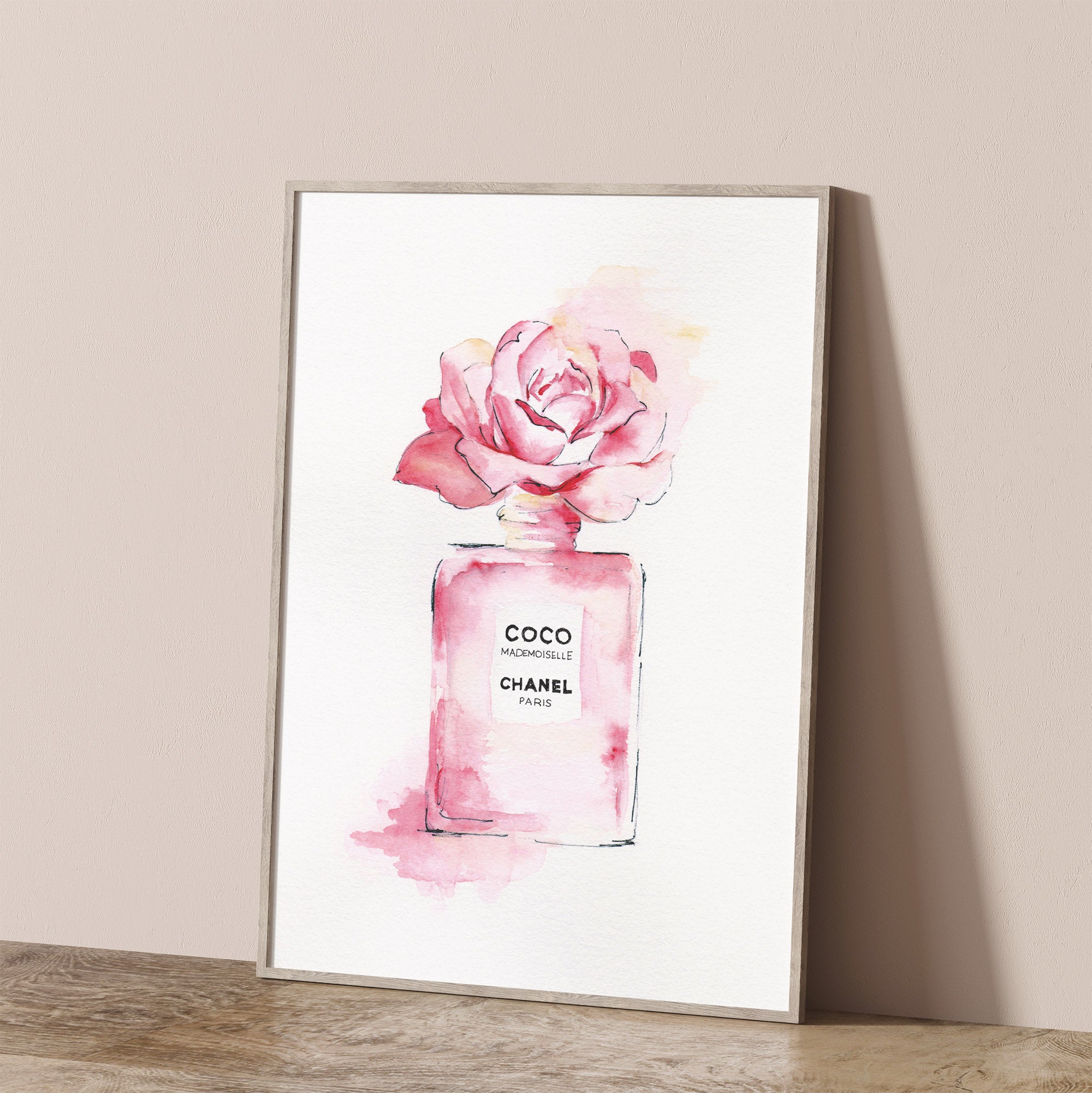 Designer wall art with a Chanel perfume bottle below a rose