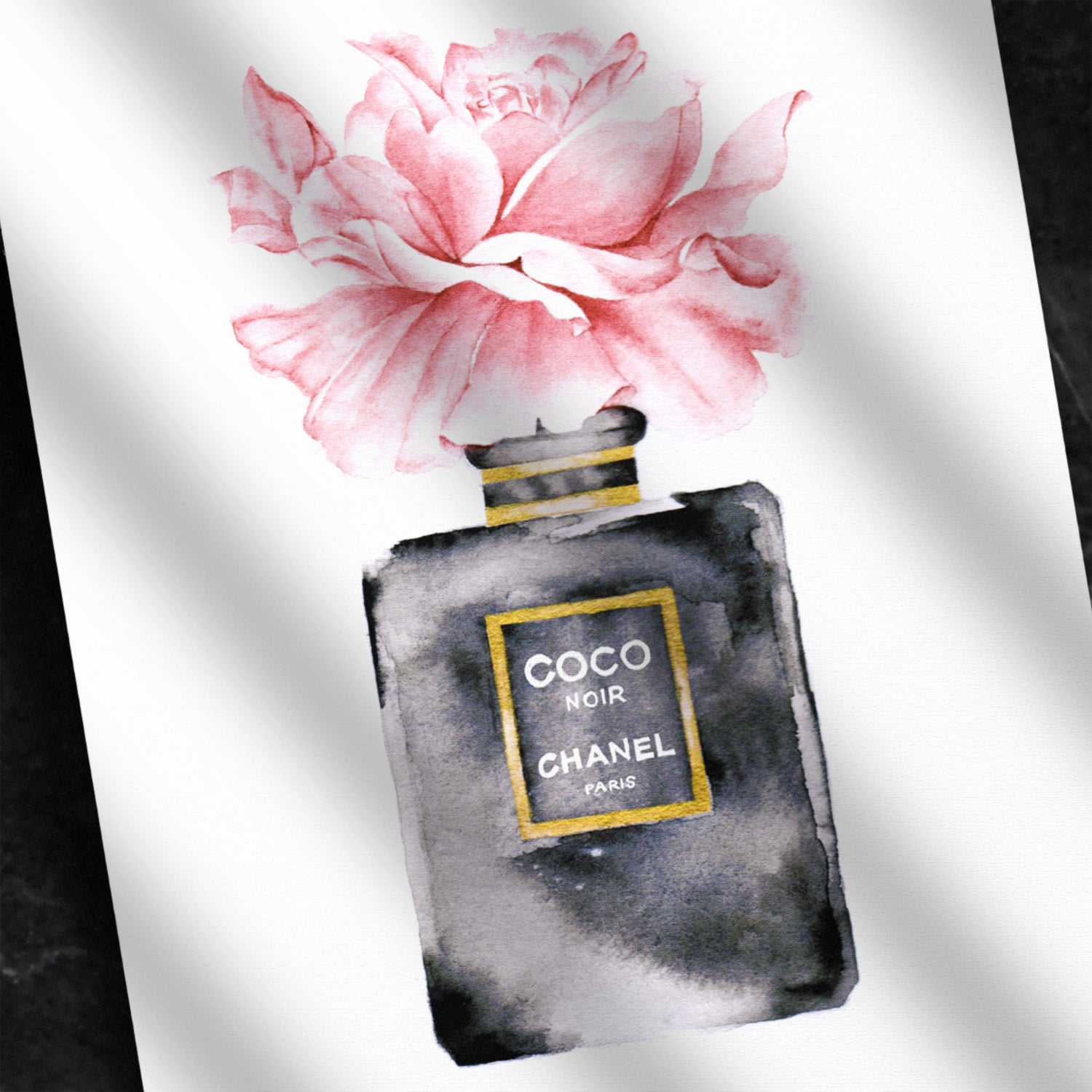 Close up of a watercolor print of a Chanel perfume bottle in black, gold and pink