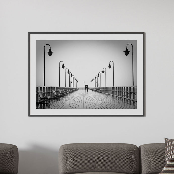 Black & white photography print featuring a couple walking in the rain