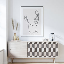 Load image into Gallery viewer, Line art face print framed above a sideboard
